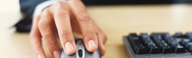 Mans hand on computer mouse.