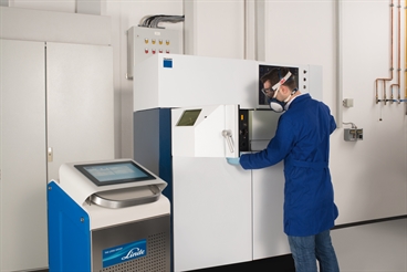 ADDvance O2 precision box with Trumpf 3D printer and employee with protection mask. Picture taken by Bernhard Rohnke.